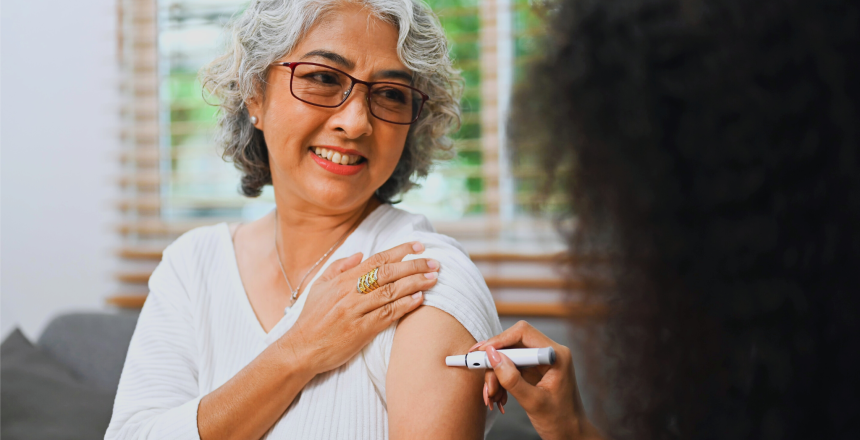 Nurse injecting insulin into upper arm of diabetic elderly patient